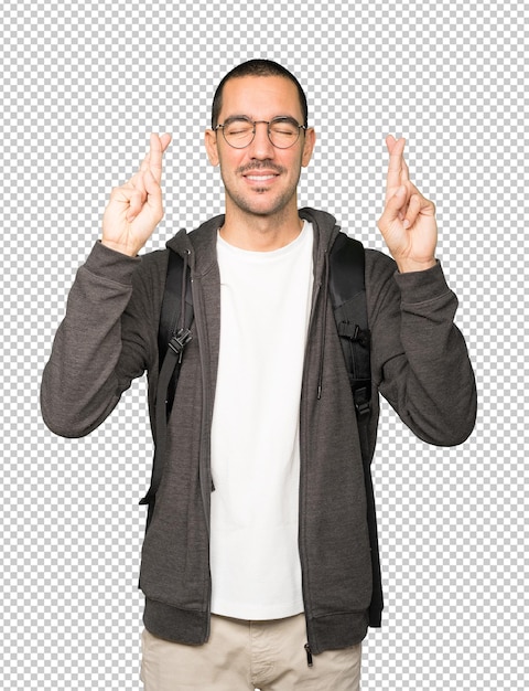 Happy student doing a crossed fingers gesture