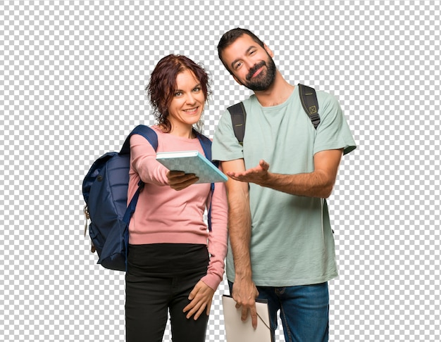 Happy two students with backpacks and books