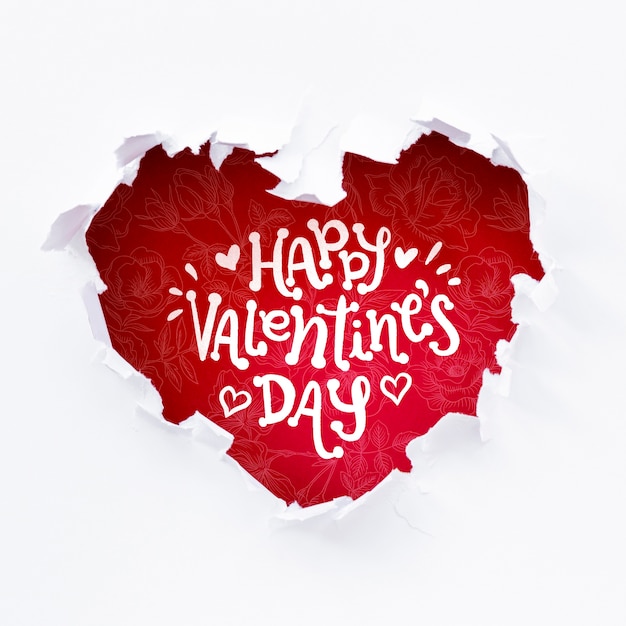 Happy valentines day lettering in red heart shaped hole