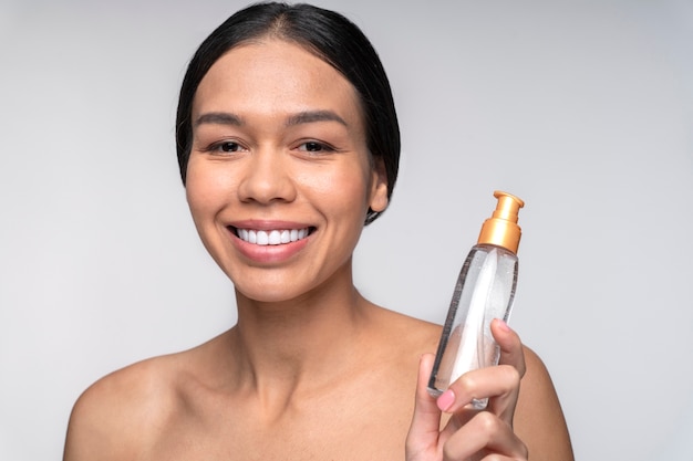 Happy woman holding container close up