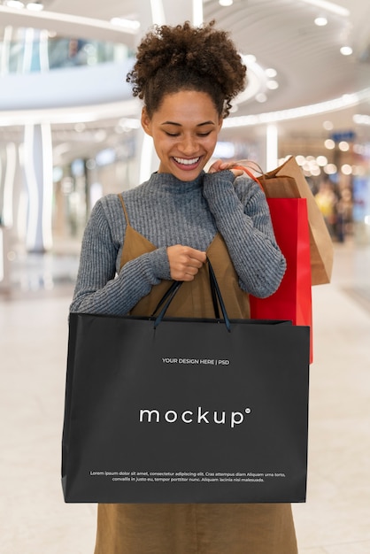 Happy woman with shopping bag mockup