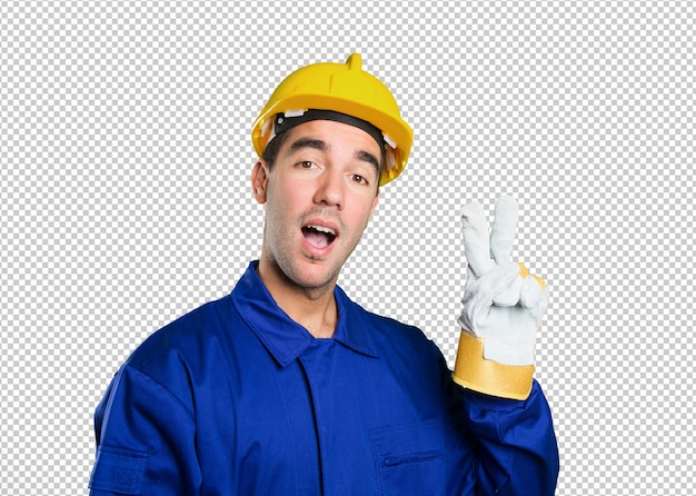 Happy worker with victory gesture on white background