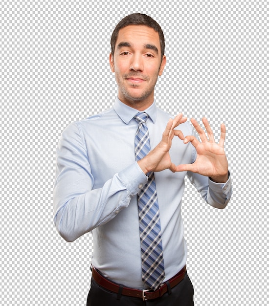 Happy young businessman with a love gesture