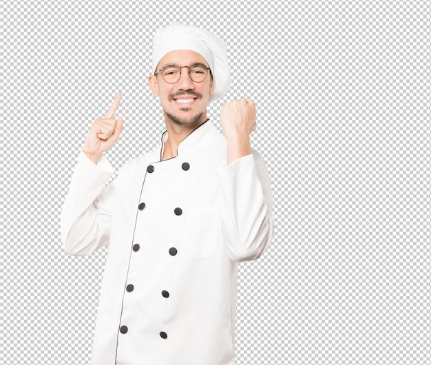 Happy young chef doing a competitive gesture