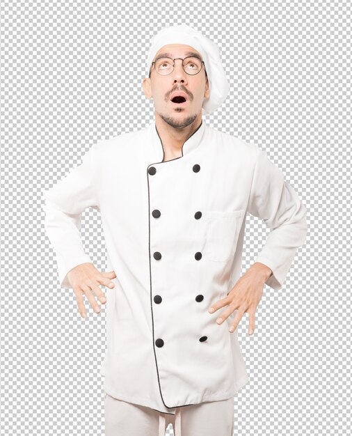 Happy young chef looking up gesture