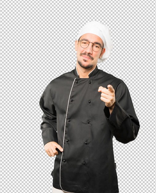 PSD happy young chef pointing at you with his finger