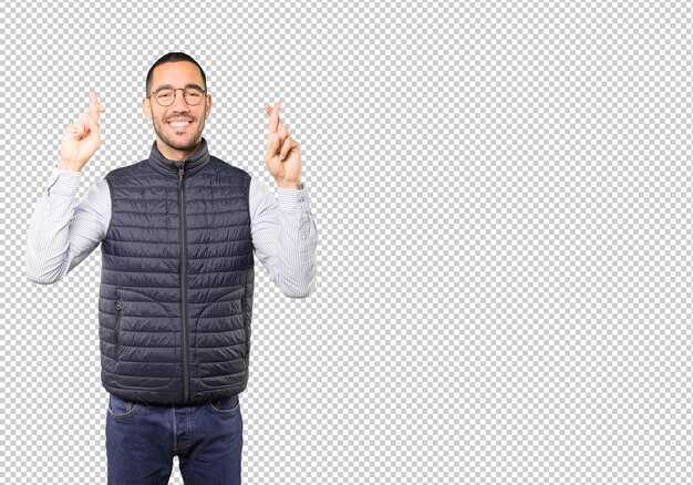 PSD happy young man doing a crossed fingers gesture