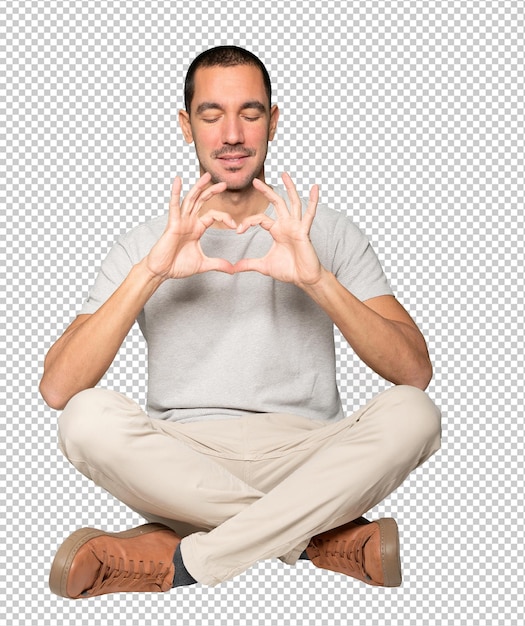 Happy young man doing a gesture of love with his hands