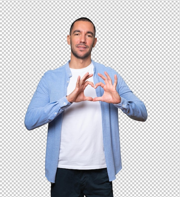 Happy young man doing a gesture of love with his hands