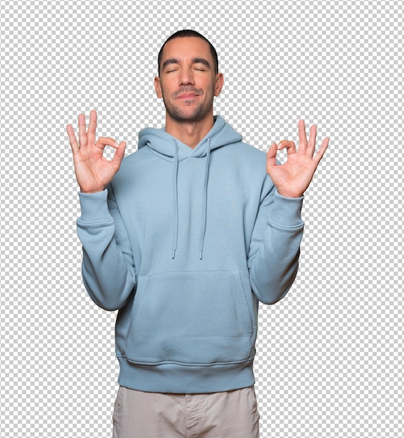 Happy young man doing a gesture of meditation