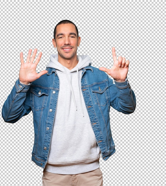 Happy young man doing a number seven gesture with his hands