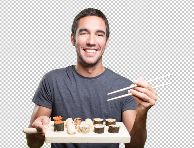 Happy young man eating sushi