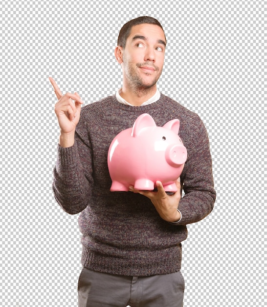 Happy young man holding a piggy bank