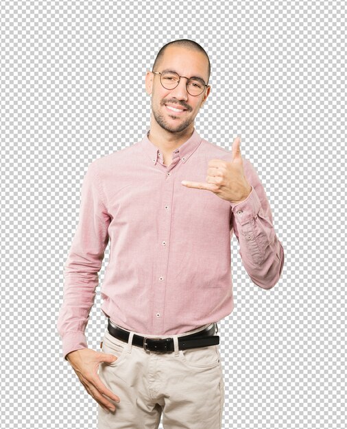 Happy young man making a gesture of calling with the hand