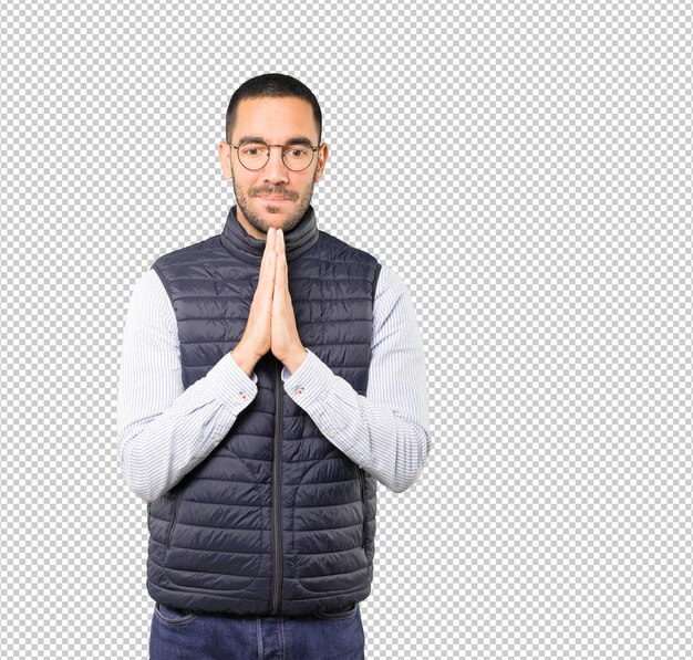 Happy young man praying gesture