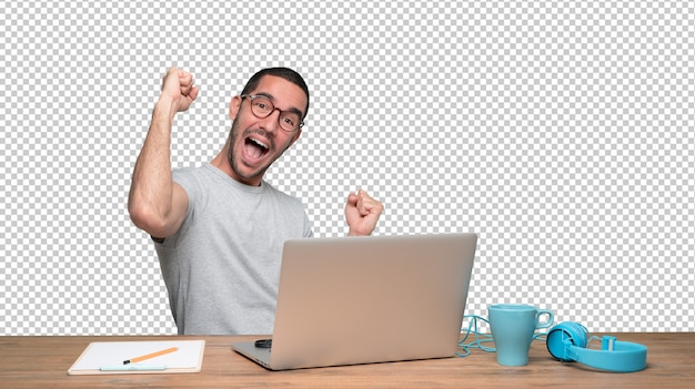 PSD happy young man sitting at his desk with a gesture of celebration