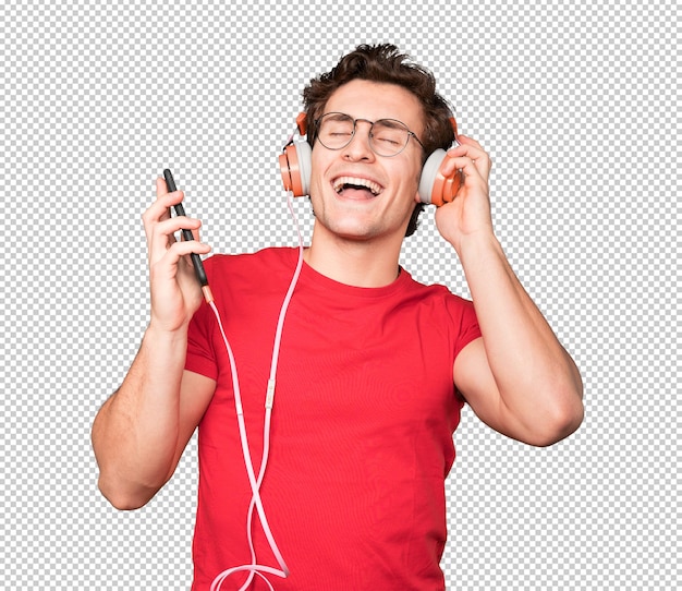 Happy young man using headphones and a smartphone