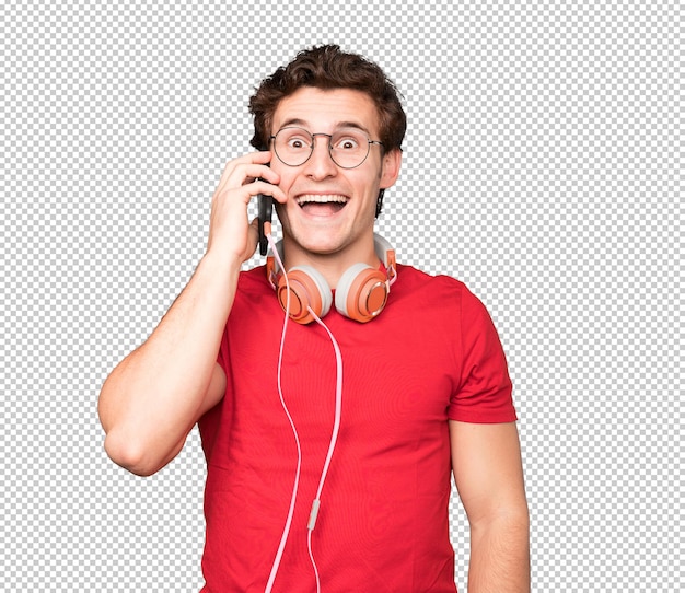 Happy young man using headphones and a smartphone