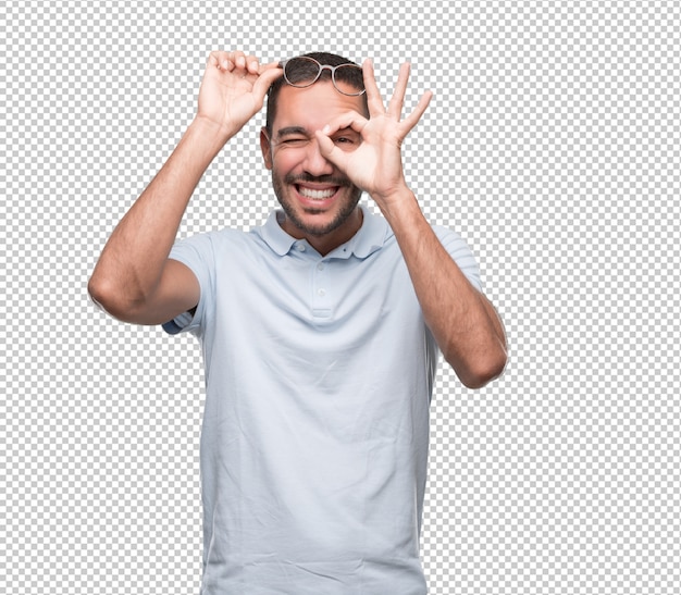 PSD happy young man with a gesture of looking through his hand