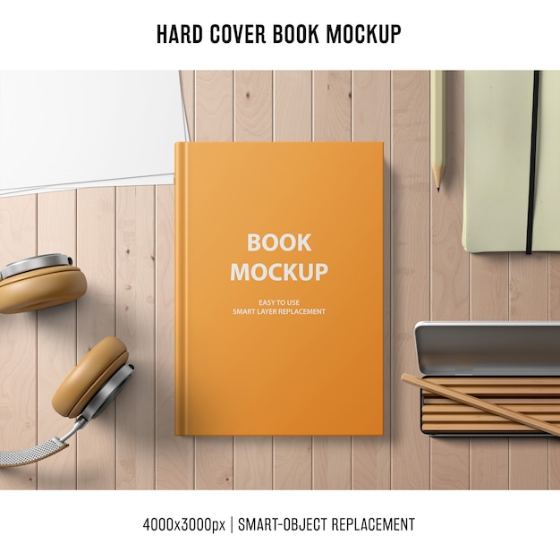 hard cover book mockup with headphones and pencils