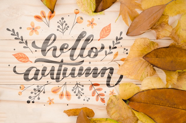 PSD hello autumn lettering on wooden background