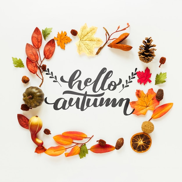 Hello autumn quote with dried leaves and fruit