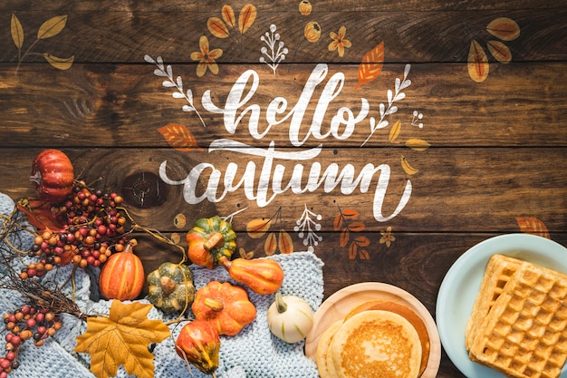 PSD hello autumn quote with pancakes and wooden background