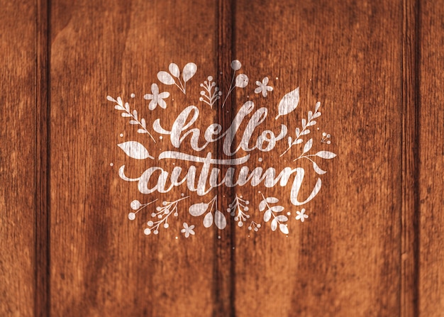 PSD hello autumn written on a wooden background