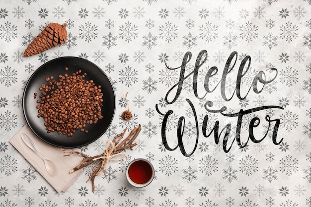 Hello winter message and coffee on table