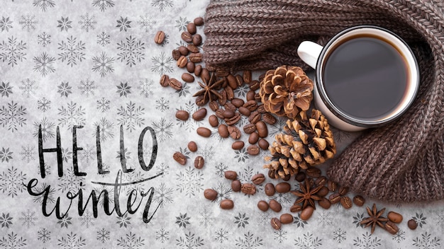 hello winter message next to winter arrangement