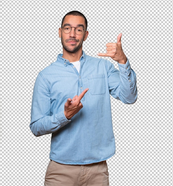 Hesitant young man making a gesture of calling with the hand