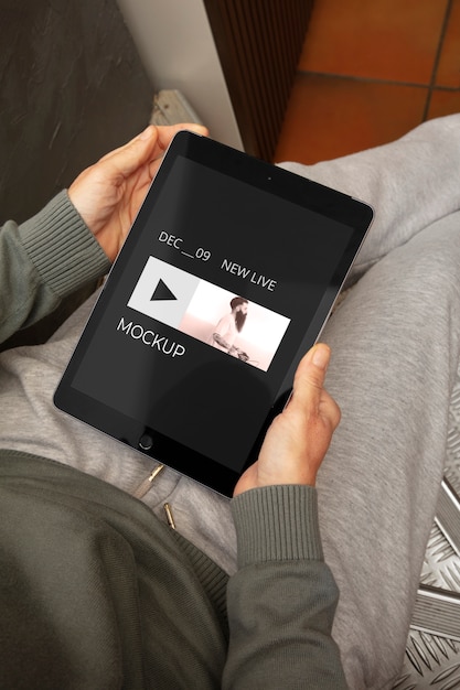 high angle adult relaxing with tablet mockup