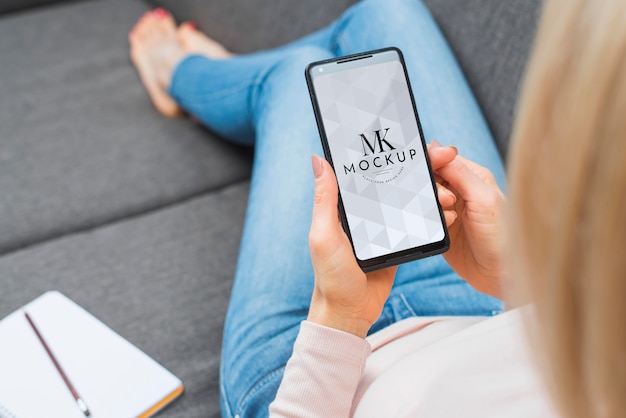 PSD high angle of blonde woman working on smartphone