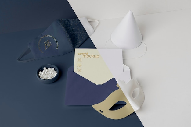 High angle of carnival invitation with envelope and mask