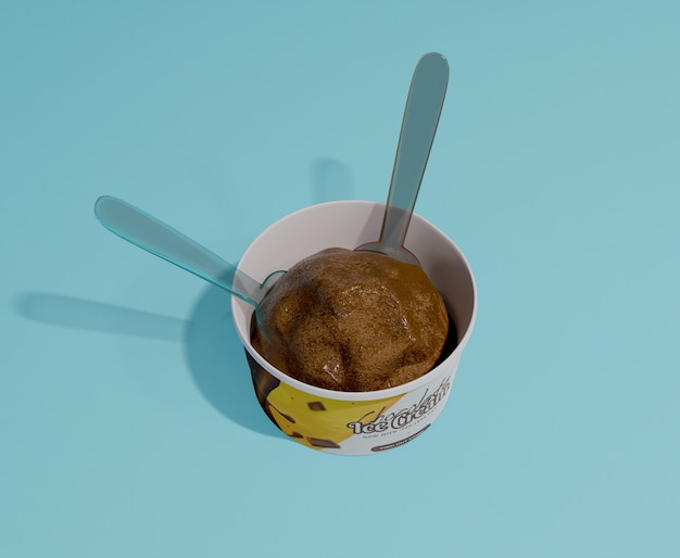 PSD high angle of chocolate ice cream in container with two plastic spoons