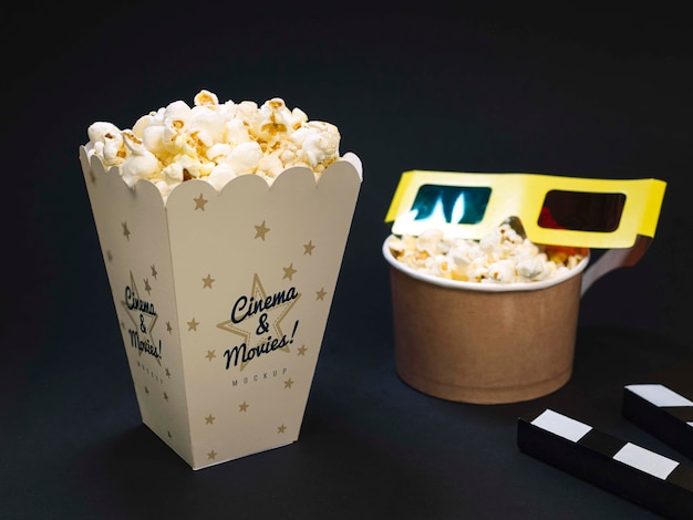 High angle of cinema glasses with popcorn and clapperboard