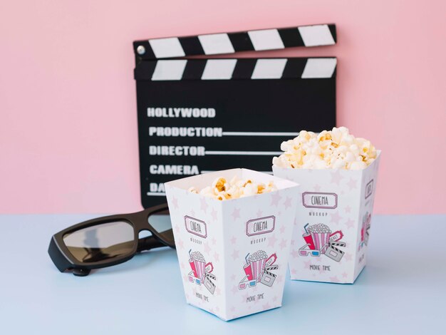 High angle of clapperboard with cinema popcorn