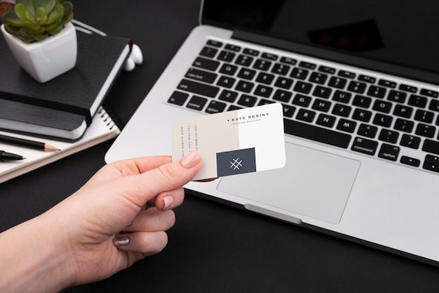 High angle of hand holding business card