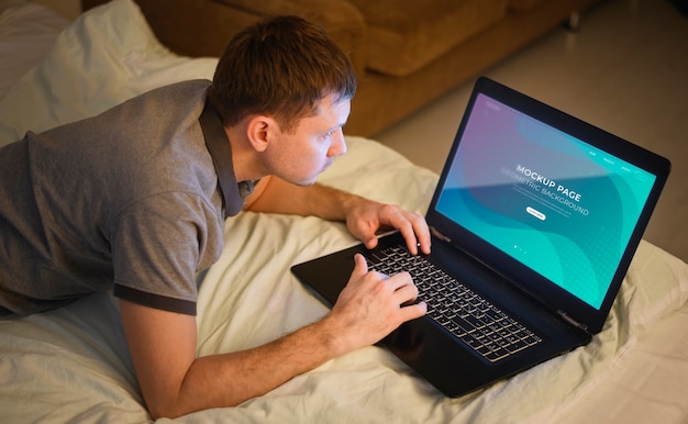 High angle of man working on laptop from home