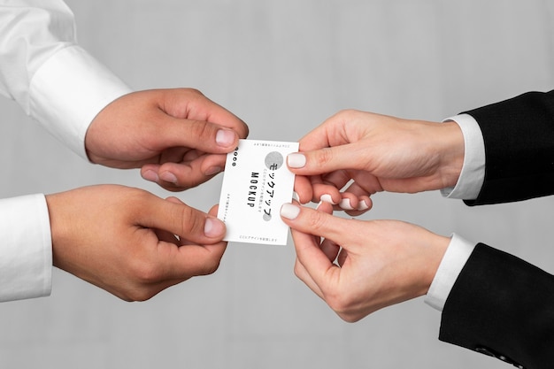 High angle men holding business cards mock-up