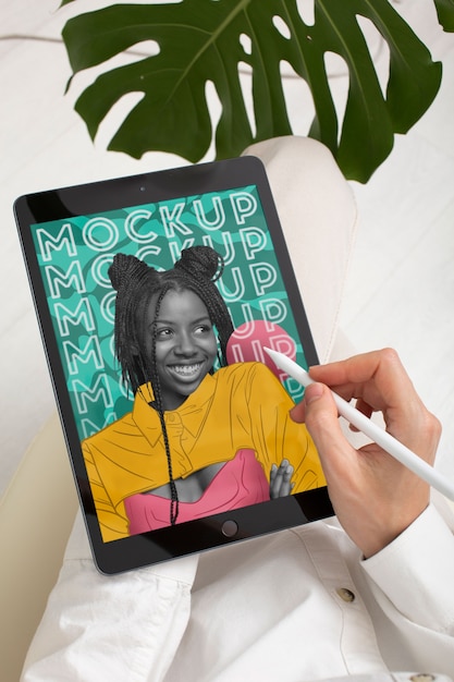 PSD high angle model holding pencil and tablet mockup