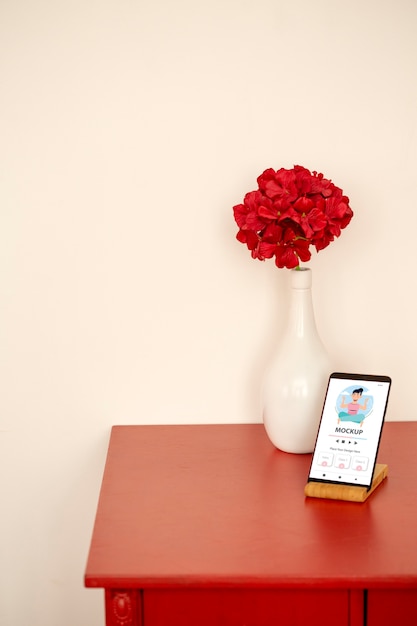 High angle smartphone and flowers arrangement