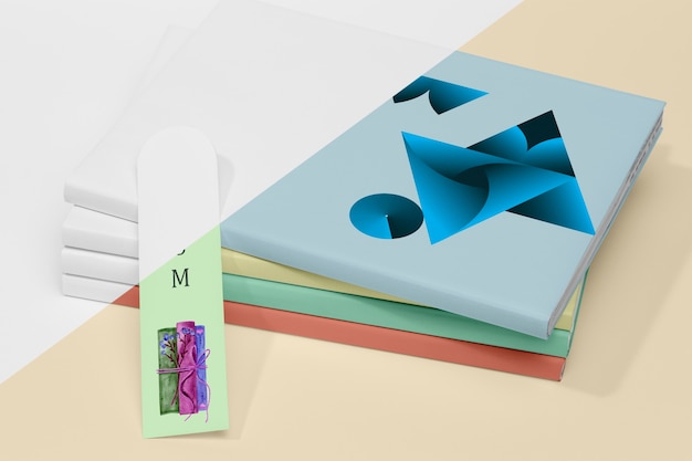 High angle stack of books mock-up with bookmark