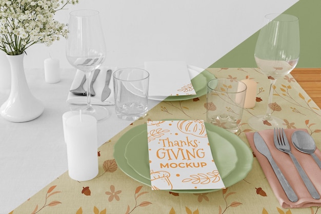 High angle of thanksgiving dinner table arrangement with plates and cutlery