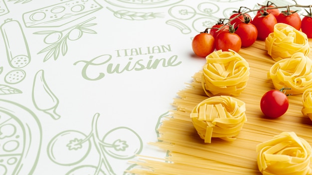 PSD high angle uncooked pasta and tomatoes with hand drawn background