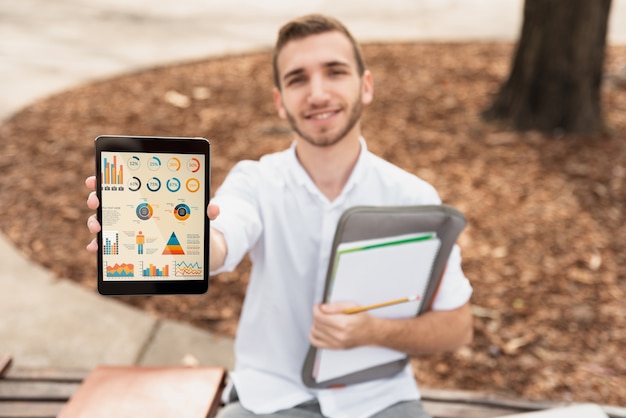 High angle university male holding tablet