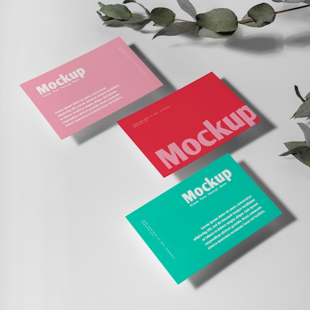 PSD high angle visit cards mockup with green leaves