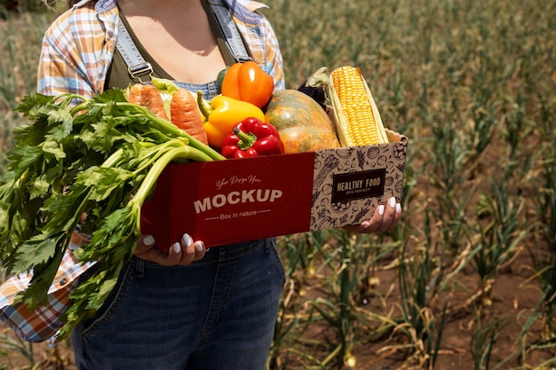 PSD high angle  woman  holding a box in nature