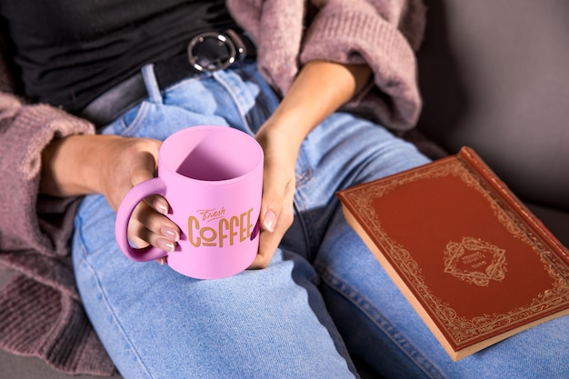 PSD high angle woman holding pink mug