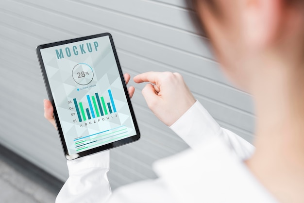 High angle of woman holding a tablet mock-up